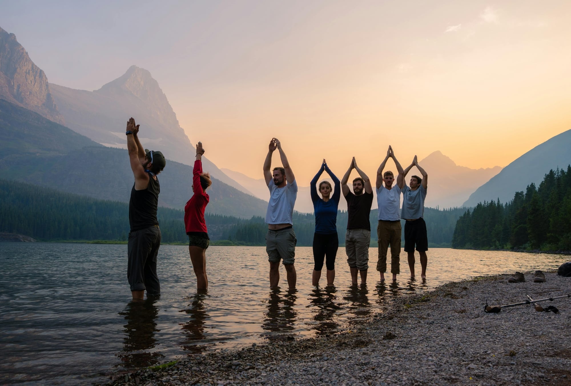Forum retreat planning: Group yoga at sunrise during a forum retreat. Team building exercise in nature.
