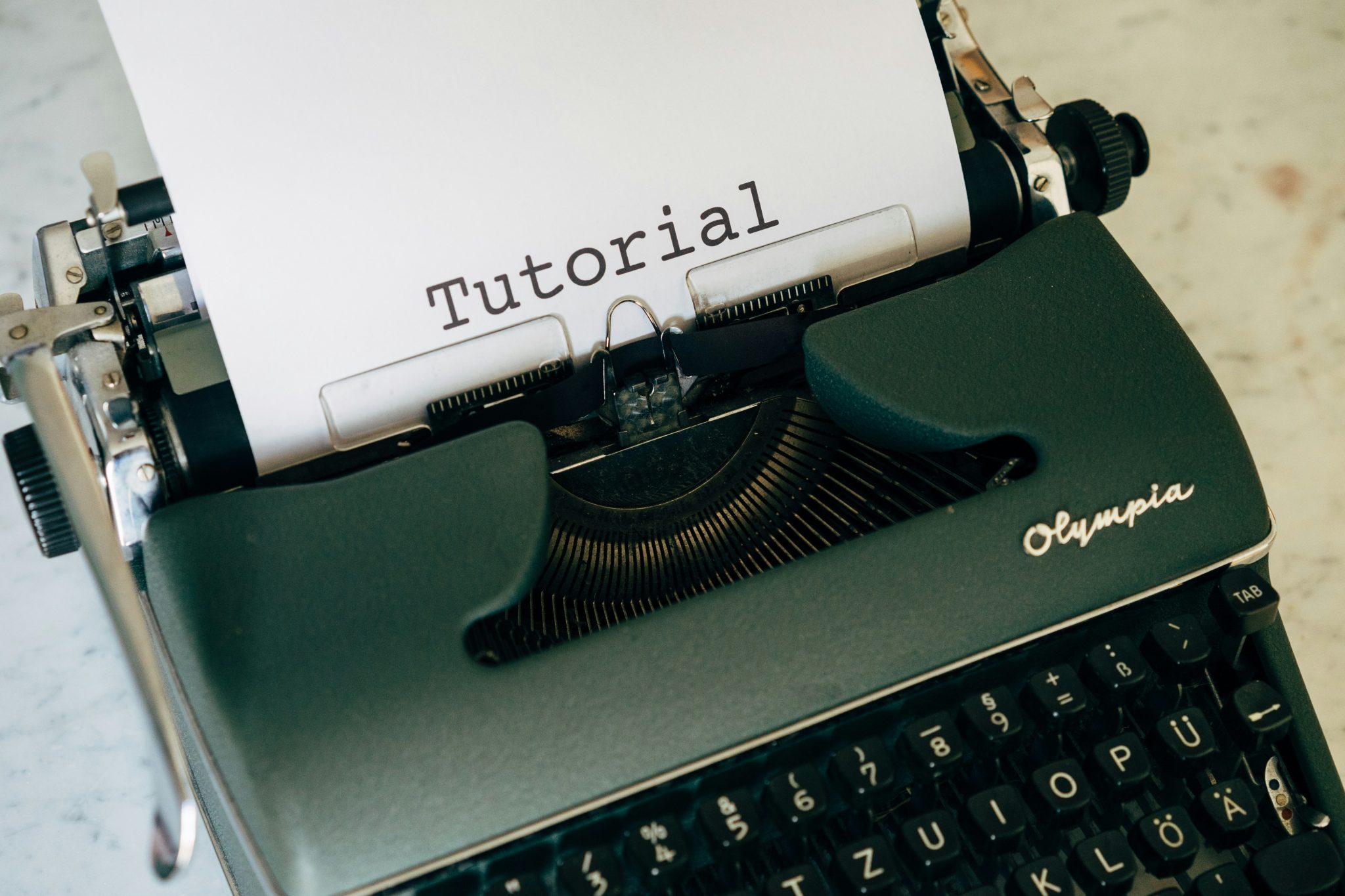 Vintage Olympia typewriter with Tutorial typed on paper. Writing tips.