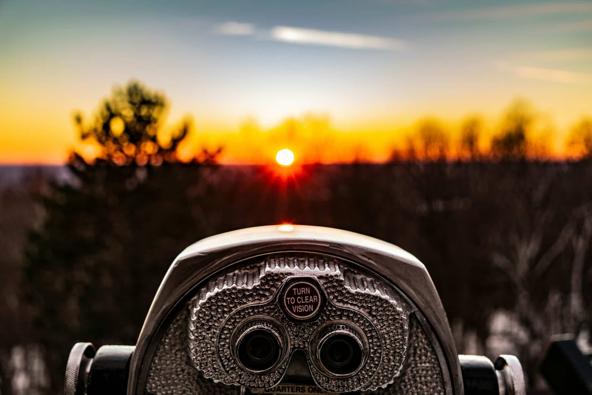 Scenic overlook binoculars at sunset, a strategic vision for your own secret strategy plan, landscape view.